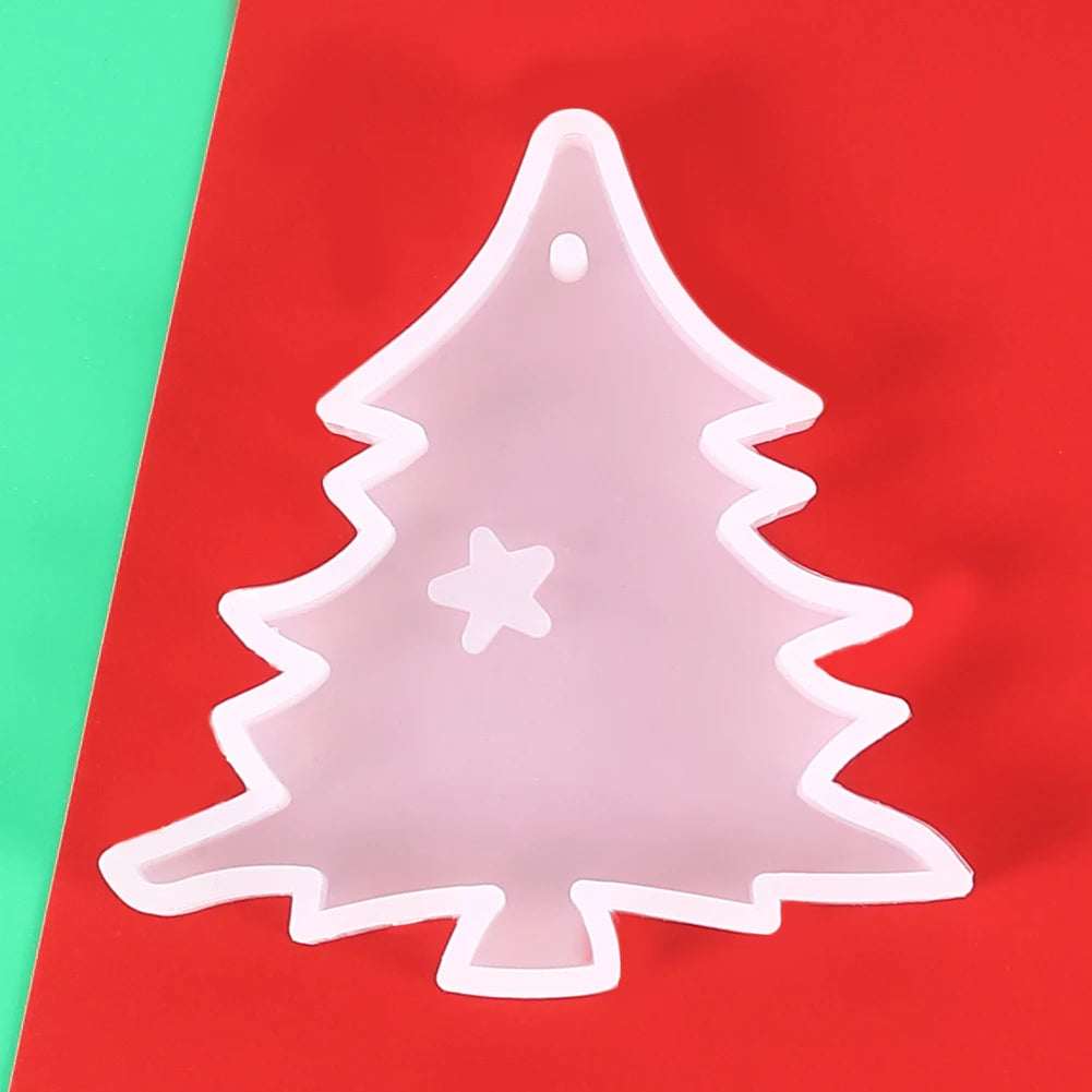 A clear silicone mold shaped like a Christmas tree with a star cutout, resting on a red surface.