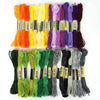 A collection of multicolor embroidery floss skeins in various shades including orange, yellow, purple, and green.