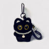 A cute plush black cat keychain charm with gold eyes and a pearl necklace.