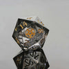 A close-up view of a translucent, faceted polyhedral die resting on its side, reflecting light.
