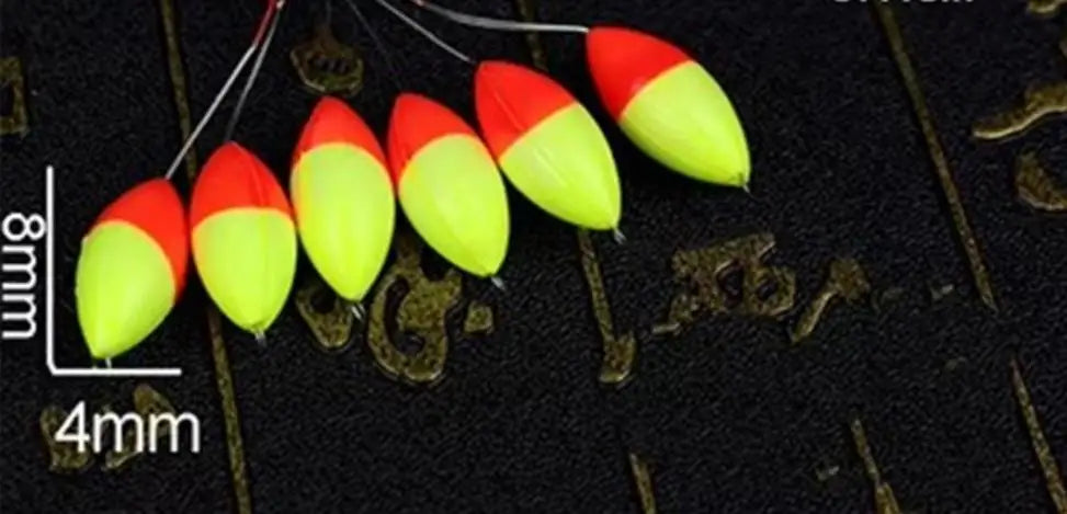 A row of bright red and yellow oval fishing floats with bobber beads are shown against a dark background.