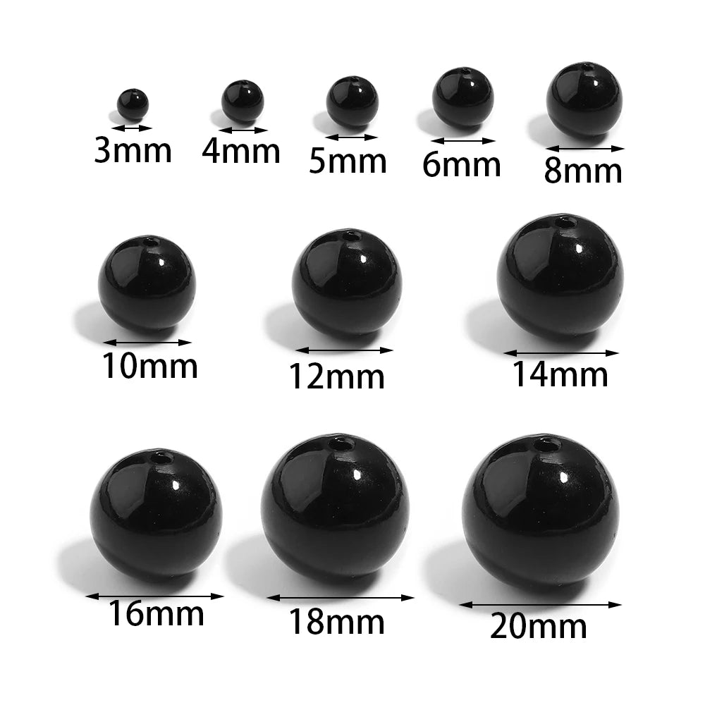 A set of black round imitation pearl beads shown in various sizes ranging from 3mm to 20mm.