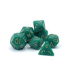 A set of seven green acrylic dice, including a triangular die, scattered on a white surface.