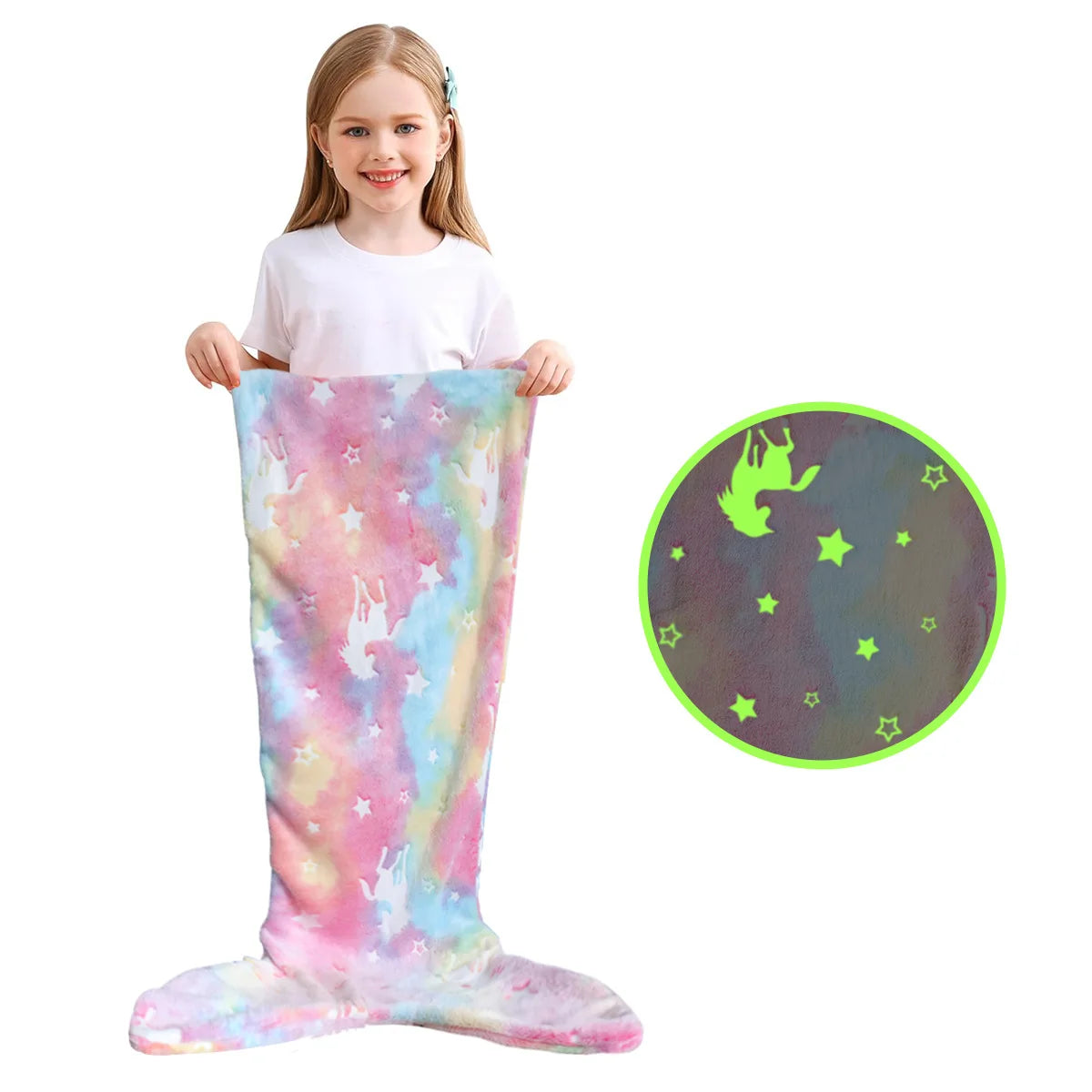 A young girl is wearing a pink and blue glow-in-the-dark mermaid tail blanket while holding a circular glow-in-the-dark desig