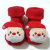 Pair of red baby anti-slip cotton socks with festive Christmas designs featuring a white beard and nose.