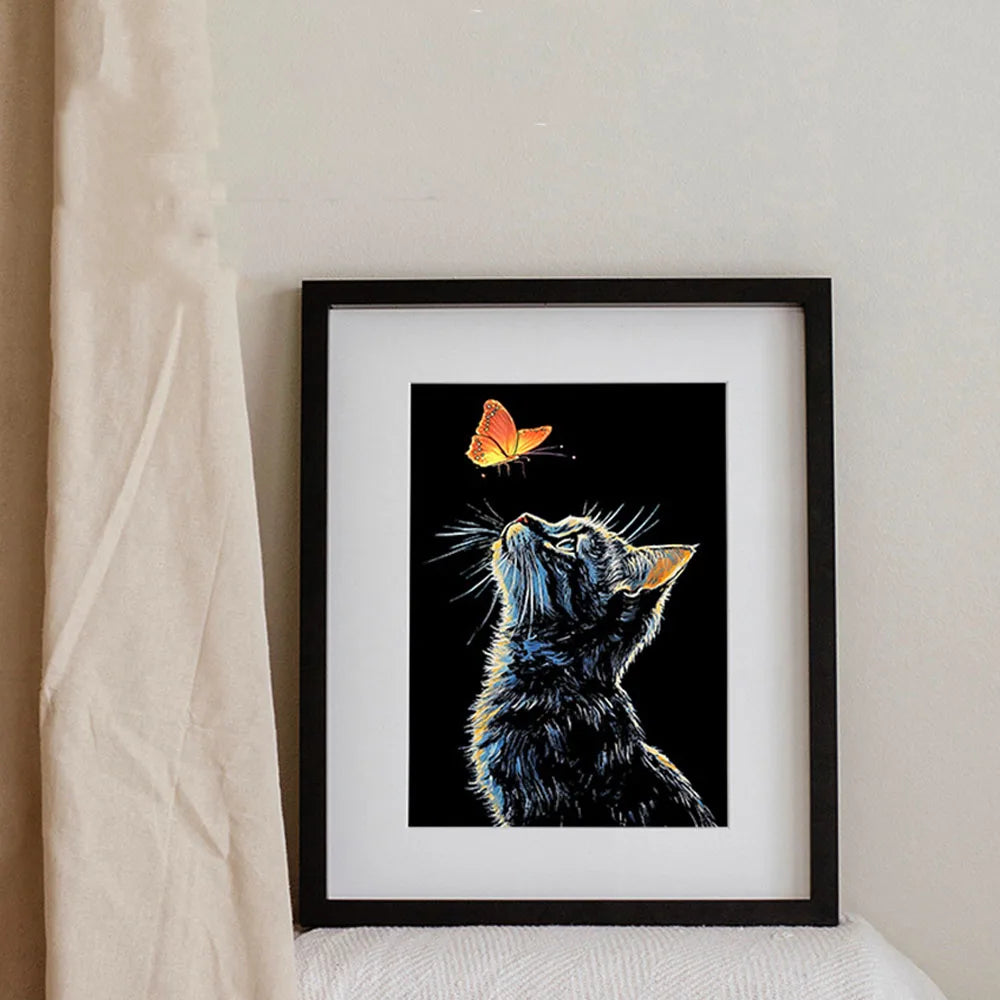 A framed black and white illustration of a cat with glowing yellow eyes and a butterfly on a black background.