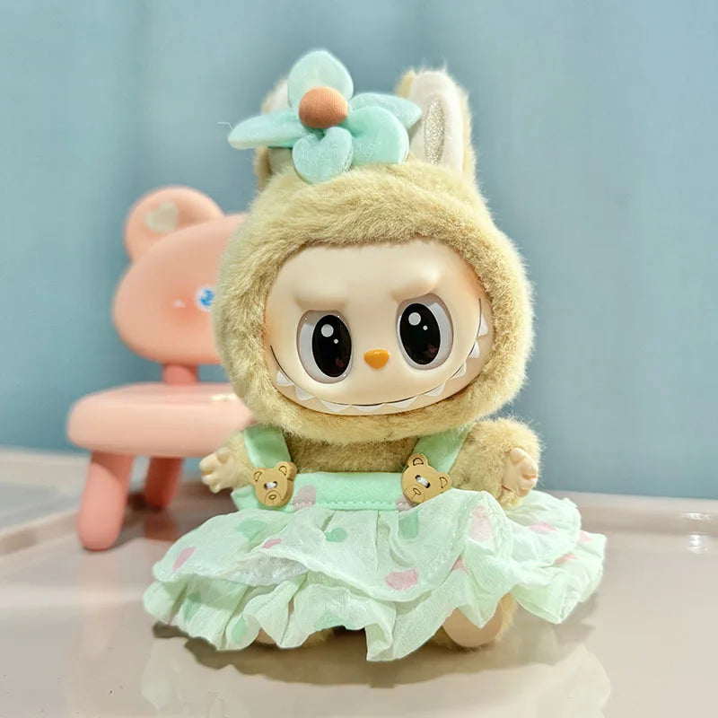 A cute yellow rabbit doll wearing a light green dress and floral headband.