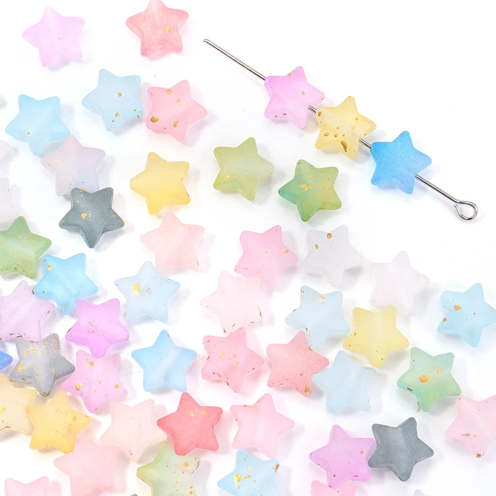 A collection of colorful transparent star acrylic beads for jewelry making, including pink, yellow, blue, and green shades.