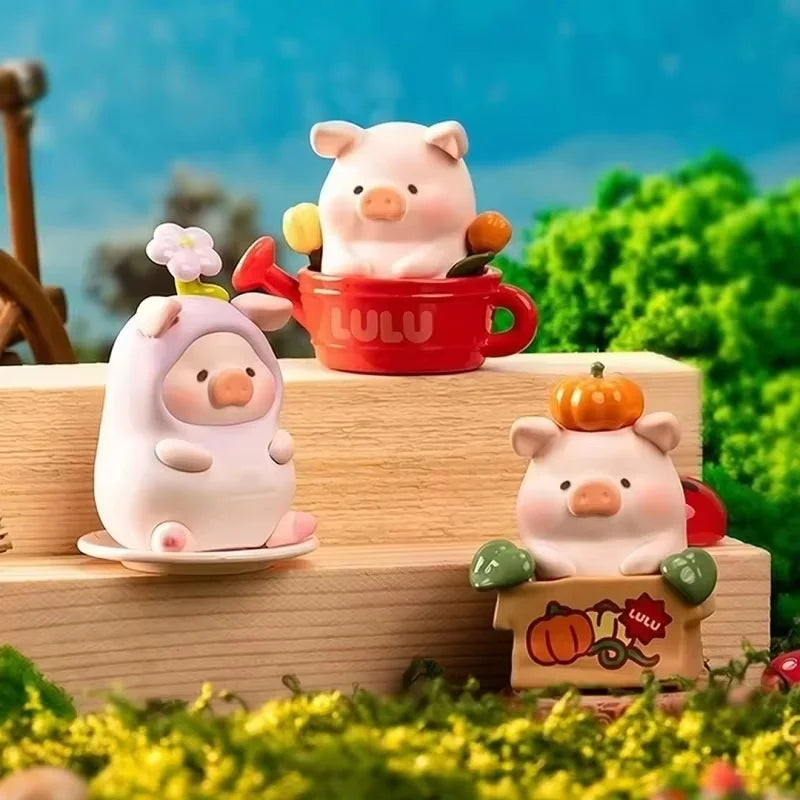 A collection of Lulu the Piggy Garden series figurines featuring pink and orange pigs in various poses on a wooden surface.