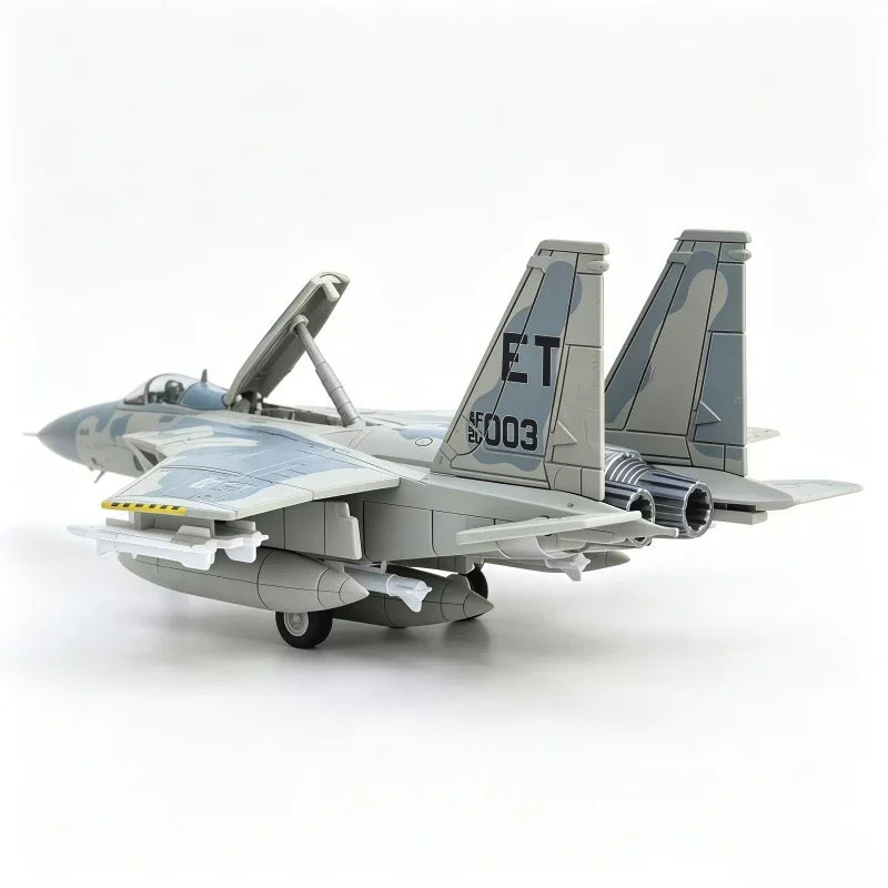 A gray F-15 Eagle fighter jet model kit with vertical stabilizers and engines displayed against a white background.