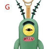 A green plush monster keychain with a rabbit face design and a gold loop.