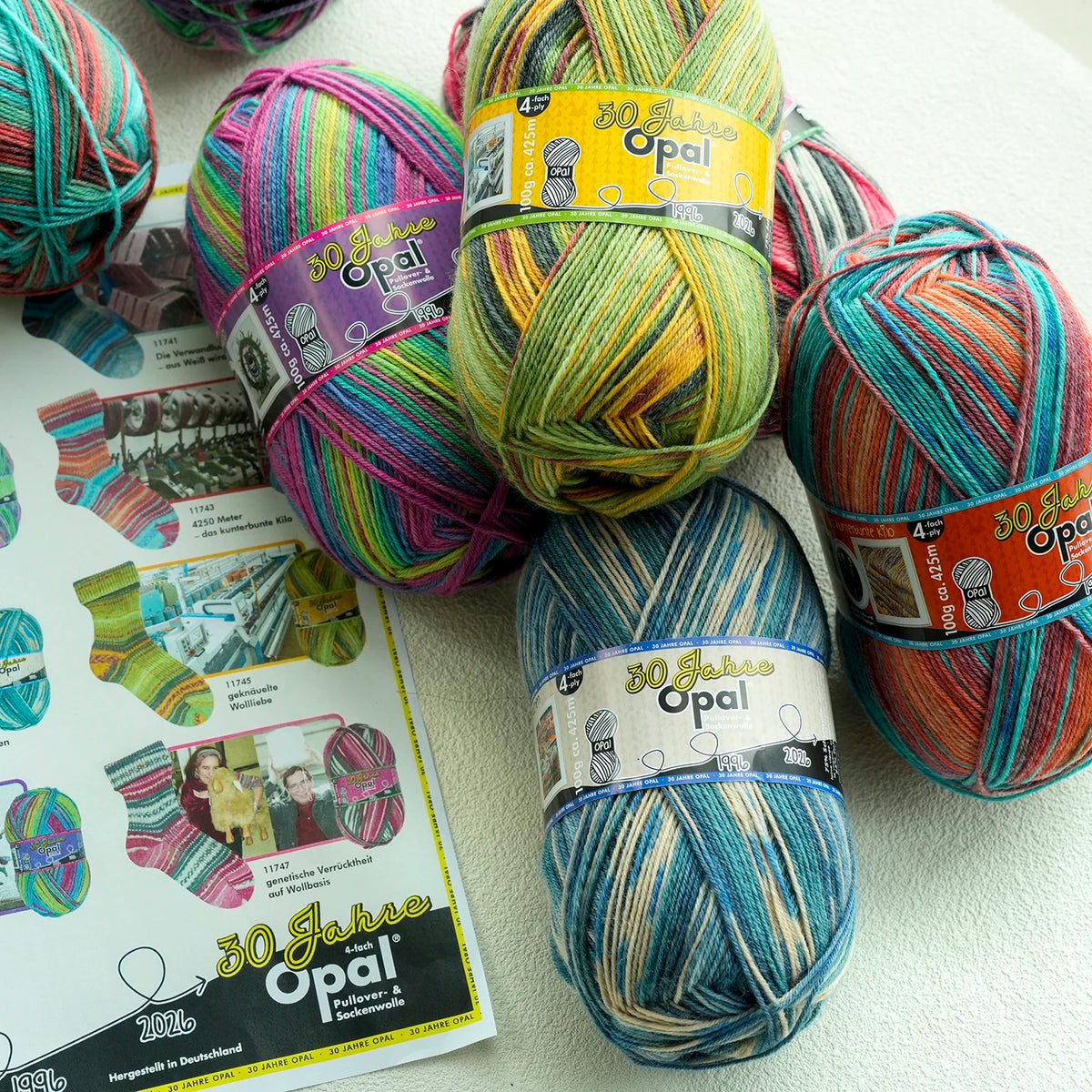A collection of colorful Opal 4-ply sock yarn balls in various shades and patterns.