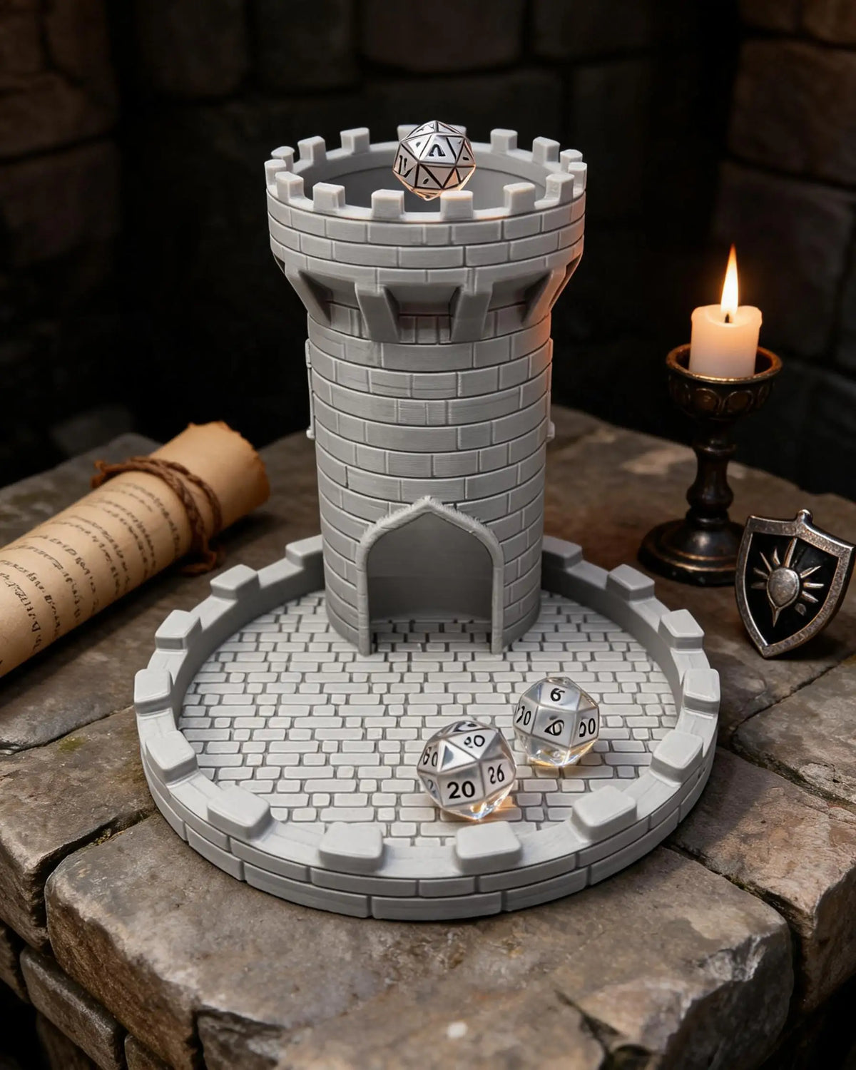 A gray medieval castle dice tower with a tray holding several polyhedral dice on a rustic wooden surface.