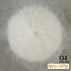 A ball of white long-haired alpaca blend yarn used for knitting, labeled as color code 01.