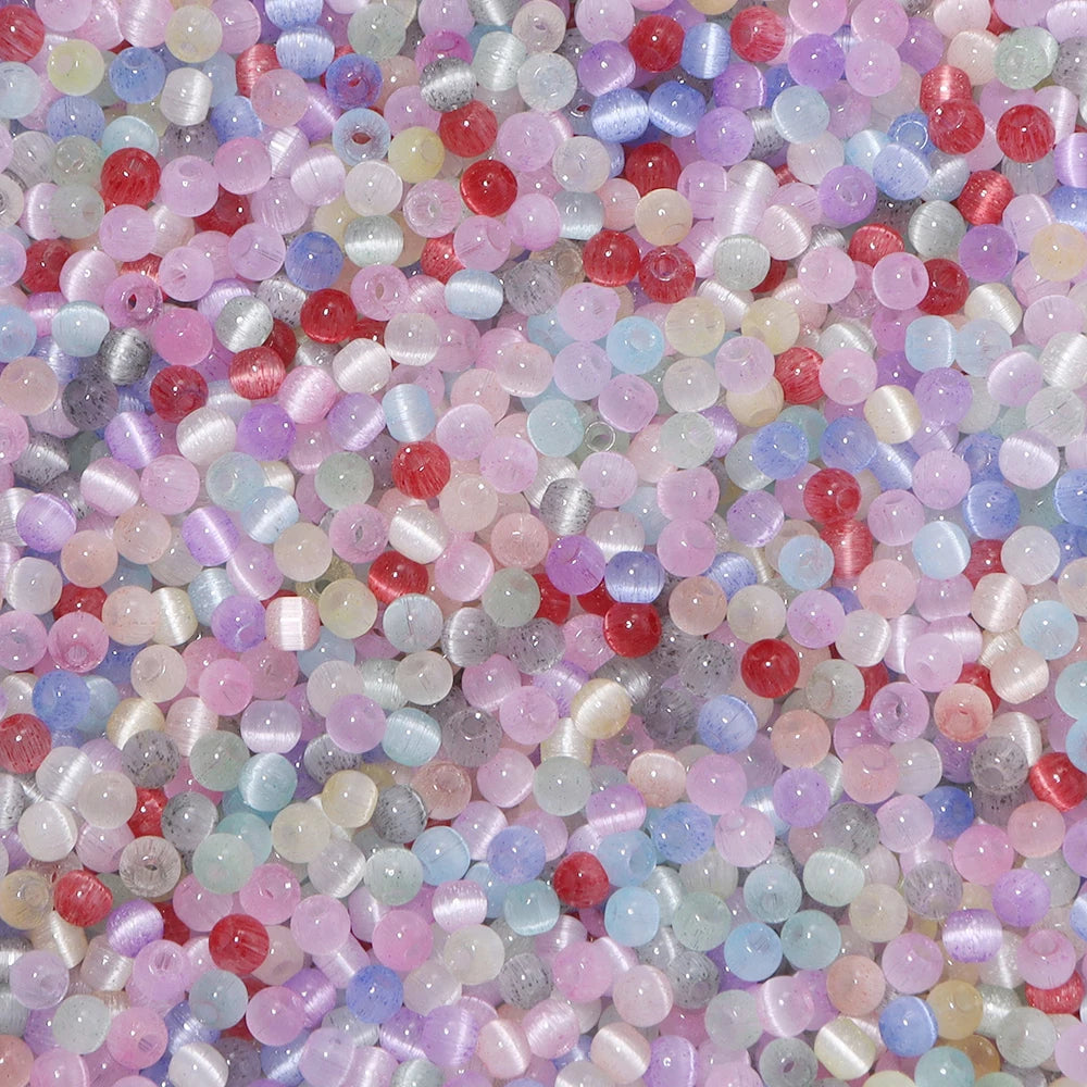 A colorful mix of 4mm cat eye glass beads in various shades including pink, purple, blue, and red.