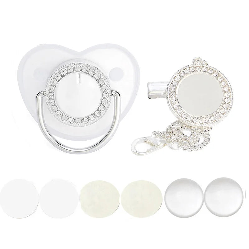 A set of white baby pacifiers and clips with rhinestone accents.