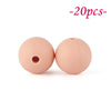 Two round, pink silicone beads are shown against a white background.