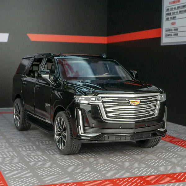 Modelo de escalado de Cadillac Escalade pull-back 1:32 en color negro sobre superficie gris.