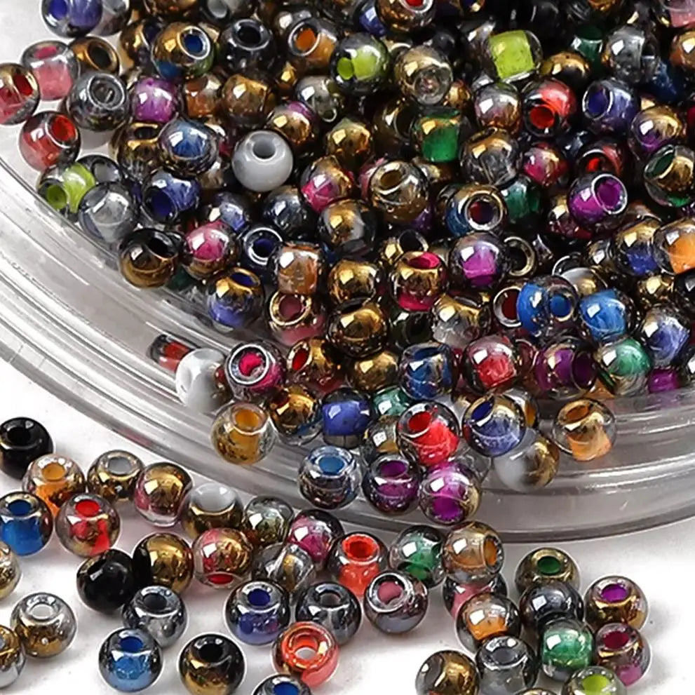 A pile of golden gradient glass beads in various colors and shades for DIY jewelry making
