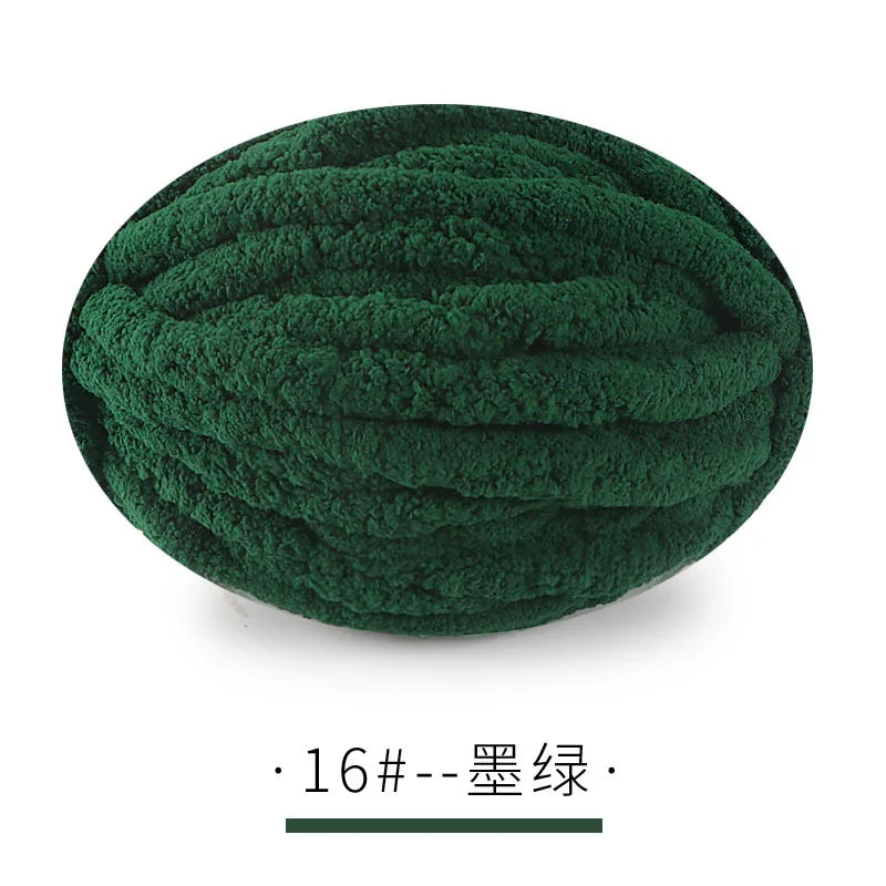 A ball of dark green chunky chenille yarn for hand knitting projects.