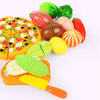 A colorful pretend play kitchen set featuring various plastic fruits and vegetables like apples, tomatoes, and peppers.