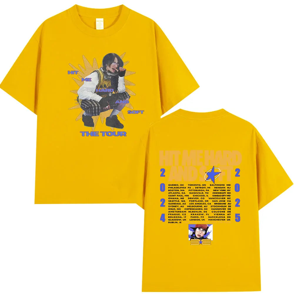 A yellow t-shirt featuring a graphic of a musician performing on stage with the text THE TOUR.