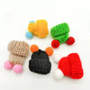 A set of mini rubber duck accessories including a yellow hat, green hat, and red hat with white accents.