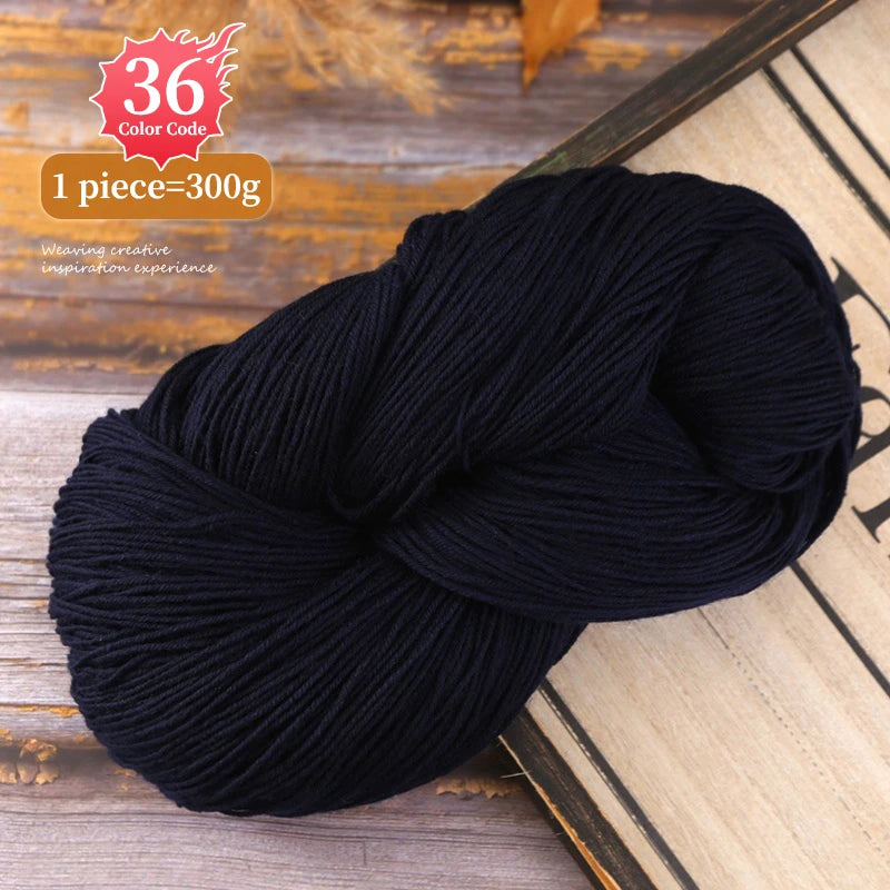 A skein of black yarn is shown on a wooden surface, indicating 36 color code and 1 piece equals 300g.