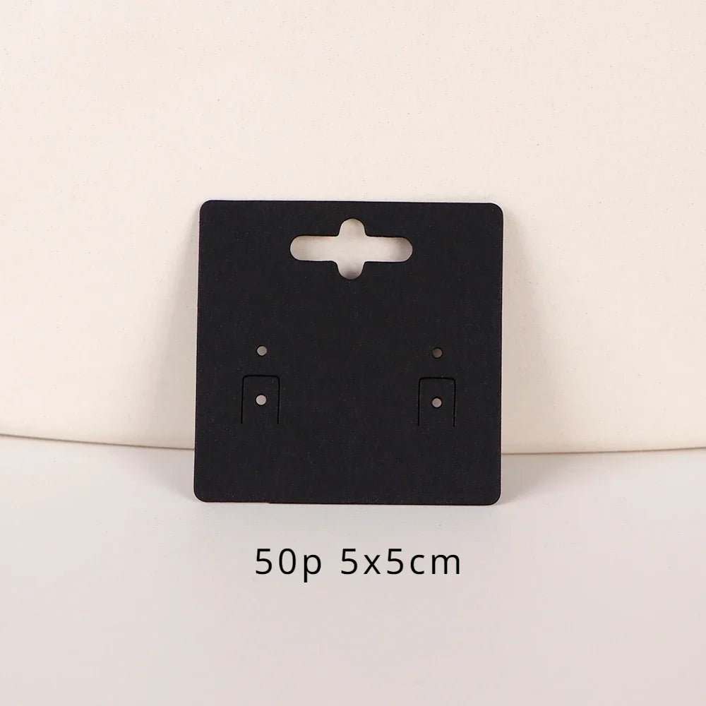 A black square jewelry display card with a cutout and two slots is shown on a white background.