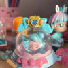 A close-up of a Teenieping Shining Meteor Aurora doll with light blue hair and a gold heart crown.