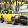 Yellow RAM Mammoth pickup truck model with black tires parked on a gray surface.
