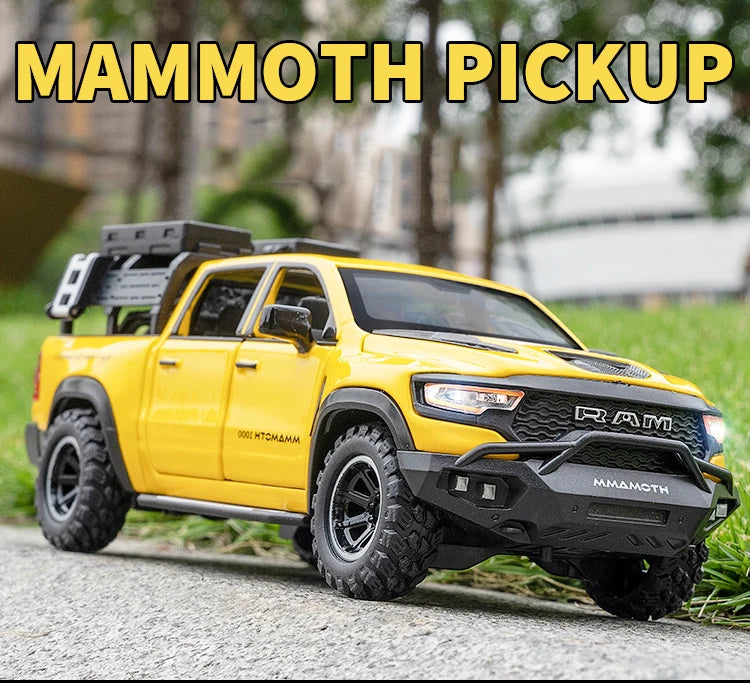 Yellow RAM Mammoth pickup truck model with black tires parked on a gray surface.