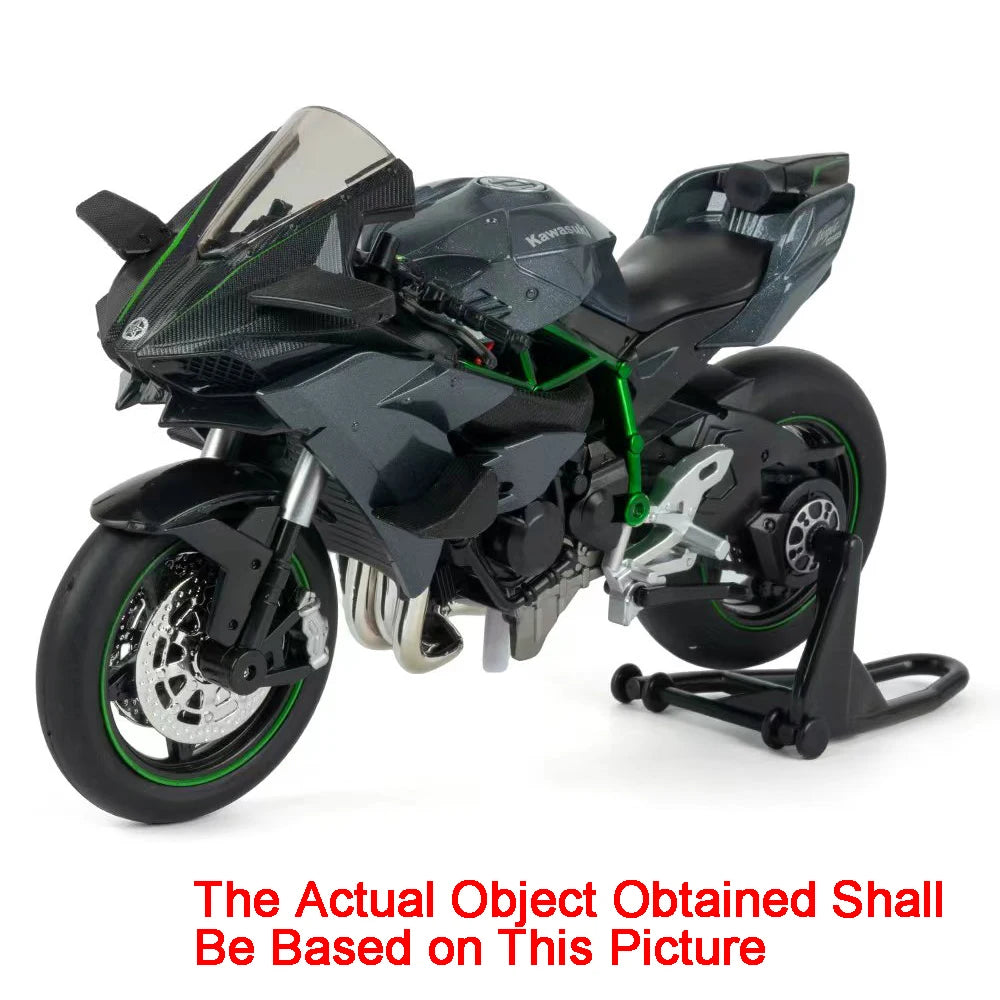 A black diecast sport motorcycle model with green accents and a clear windscreen.