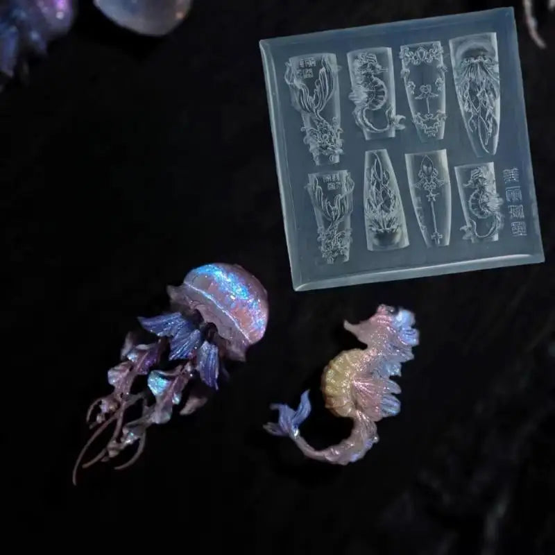 A clear silicone mold tray showing various 3D nail art designs of sea shells, starfish, and ocean creatures.