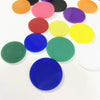 A collection of colorful plastic game markers in various shades including orange, pink, purple, yellow, red, and blue.