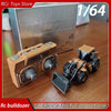 A scale model RC bulldozer kit in tan color with a remote control and a front blade, displayed on a wooden surface.