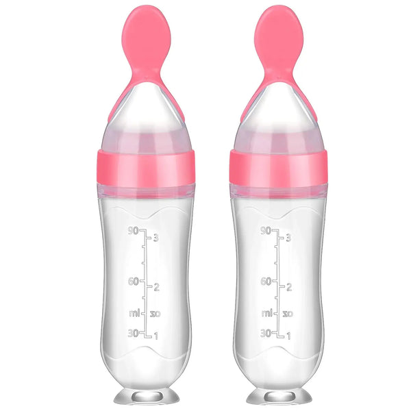 Cuillère à téter en silicone avec embout de succion rose et graduations.