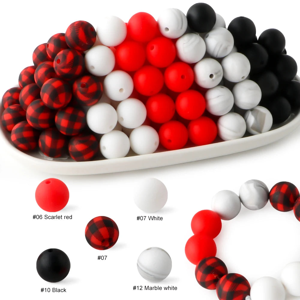 A collection of red, white, and black silicone beads for DIY jewelry and crafts.