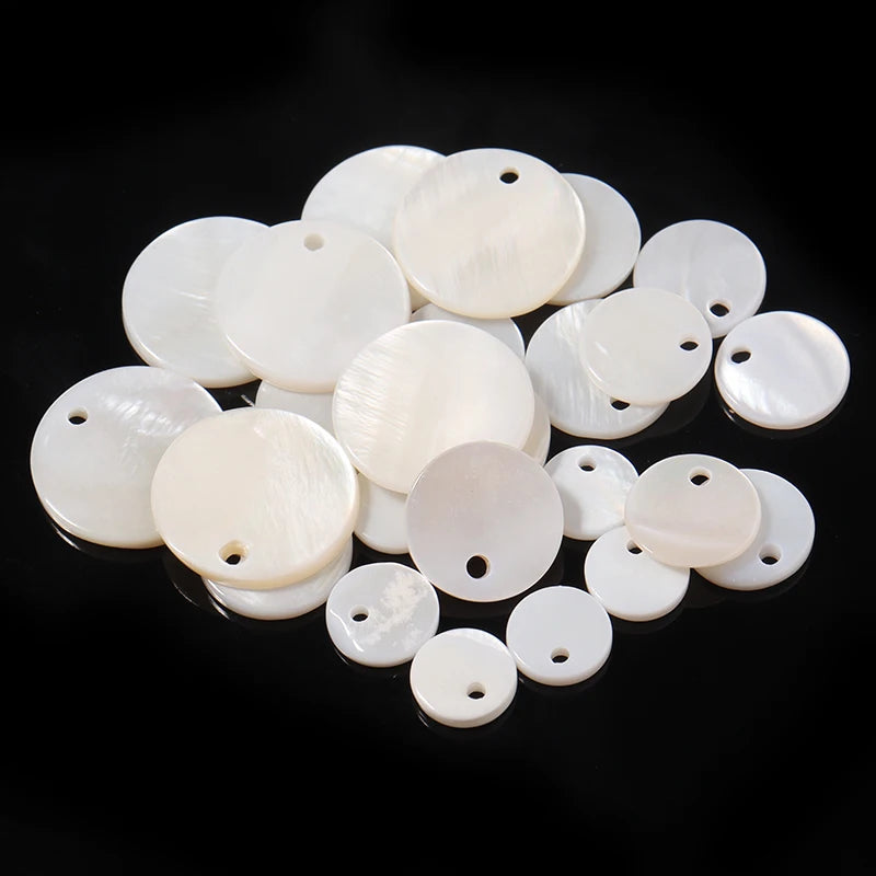 A collection of natural white shell beads in various rondelle round sizes.