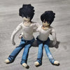 A pair of poseable L Lawliet plush dolls with dark hair and blue clothing standing side by side.