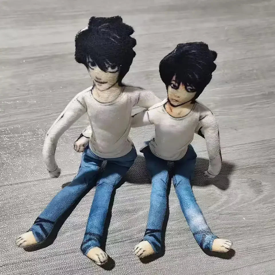 A pair of poseable L Lawliet plush dolls with dark hair and blue clothing standing side by side.