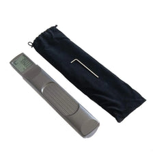 A black fabric pouch containing a pocket guitar chord trainer with a silver LCD display.