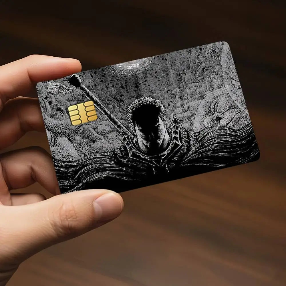 A hand holds a black card featuring an illustration of a demonic face and gold bars, designed as anime stickers.