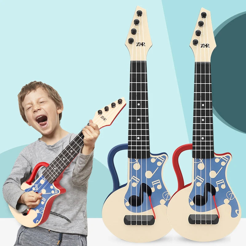 A young boy is playing a light wood ukulele toy next to two identical wooden ukuleles with blue and red accents.