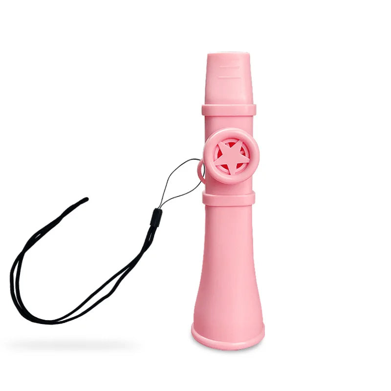 A pink portable kazoo flute with a lanyard attached, shown vertically.