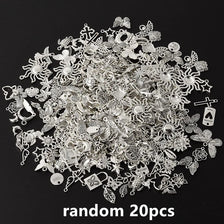 A pile of random silver and gold metal charms for DIY jewelry making