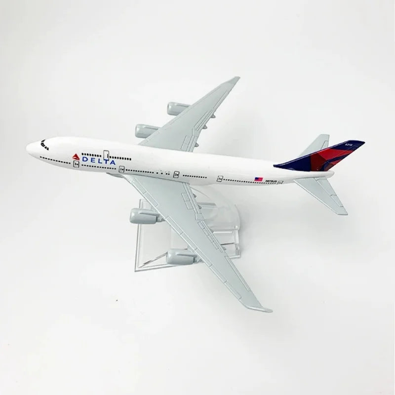 A diecast model airplane of a Delta Airlines Boeing 747 in silver and blue livery.