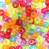 A large collection of colorful, translucent pony beads in various shades including pink, orange, yellow, green, and purple.