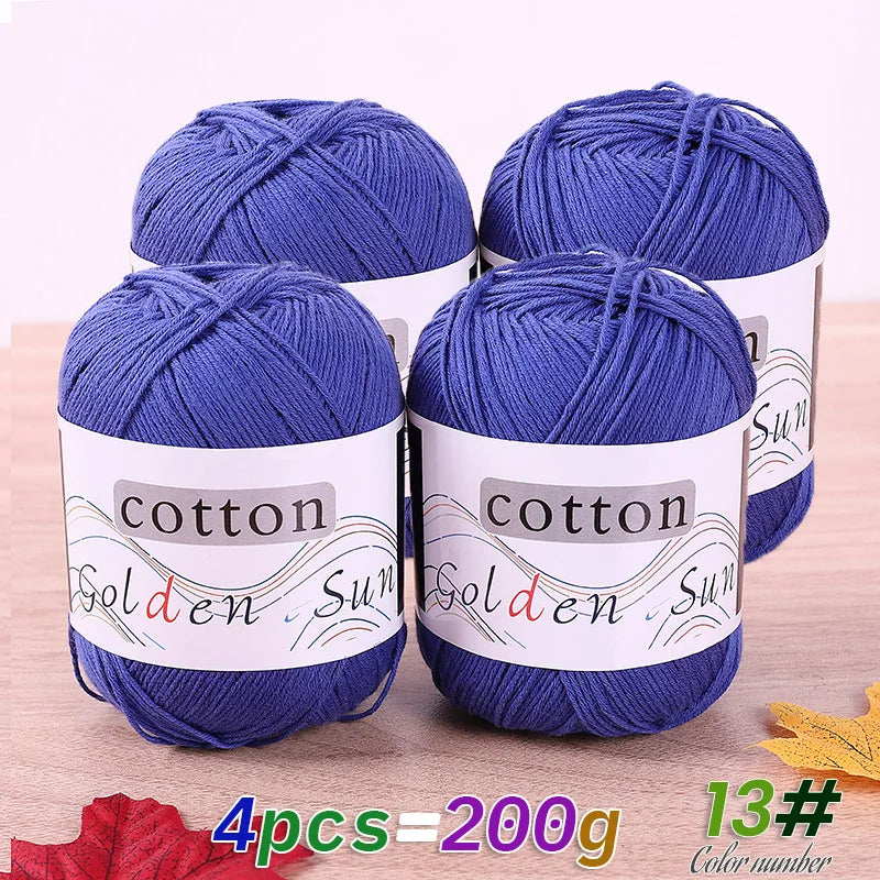Four skeins of blue cotton knitting yarn for crochet and handmade projects