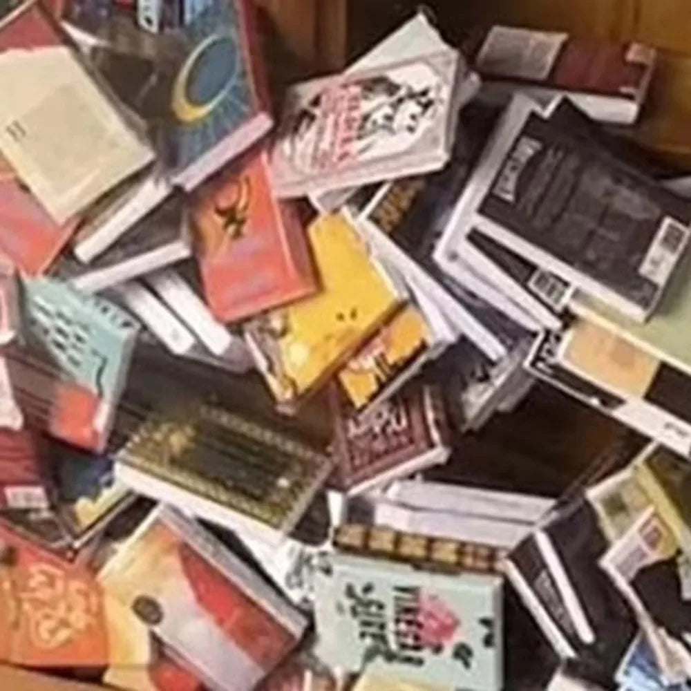 A cluttered shelf display featuring various wooden books and mini fidget items for anxiety relief decor.